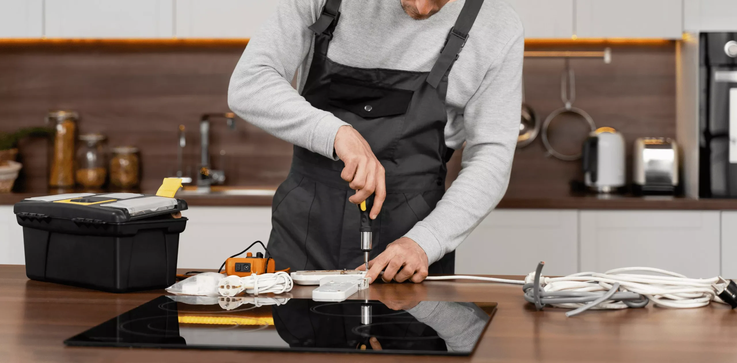 Technician installing kitchen appliance