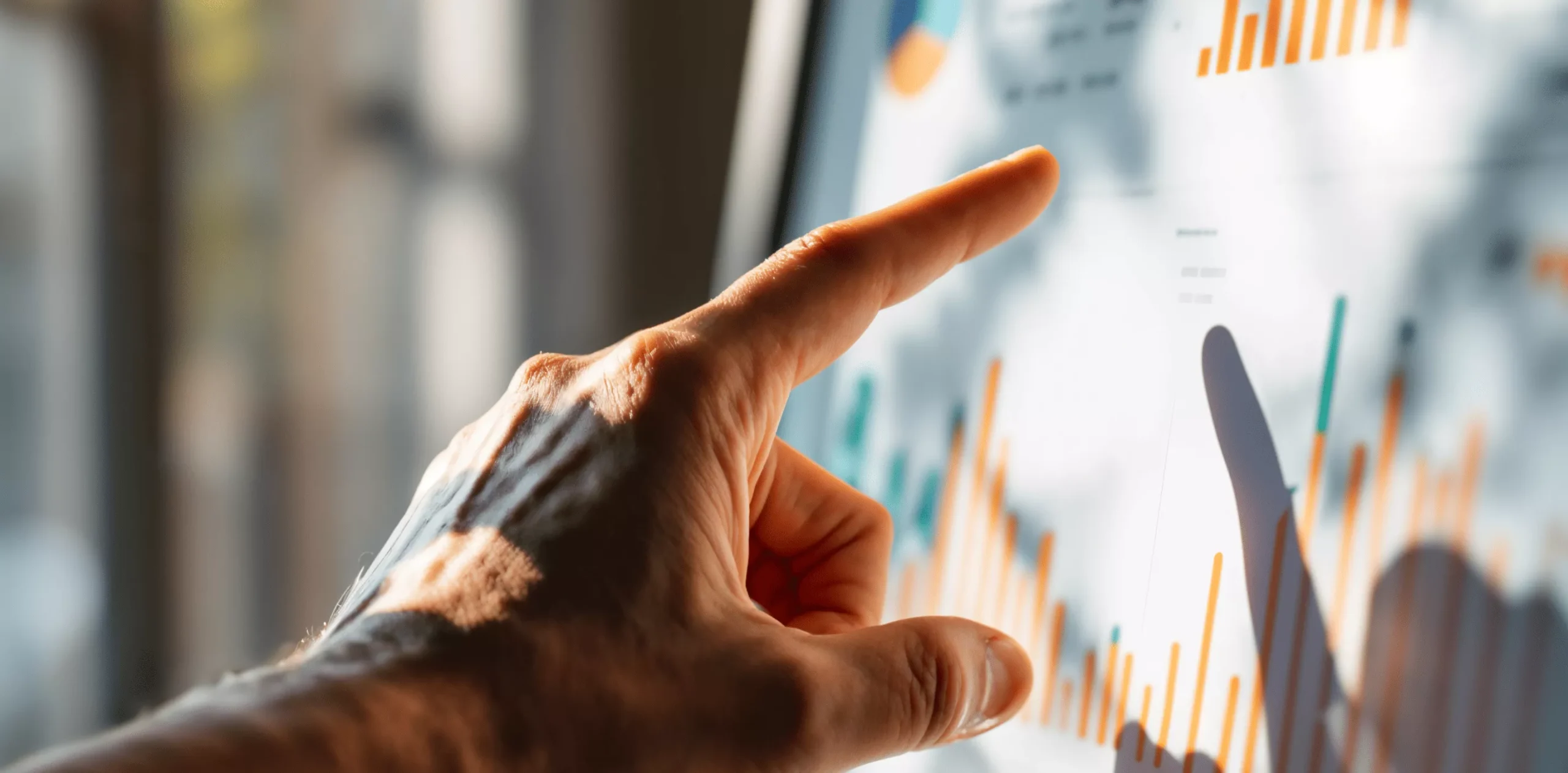 Finger pointing at data chart