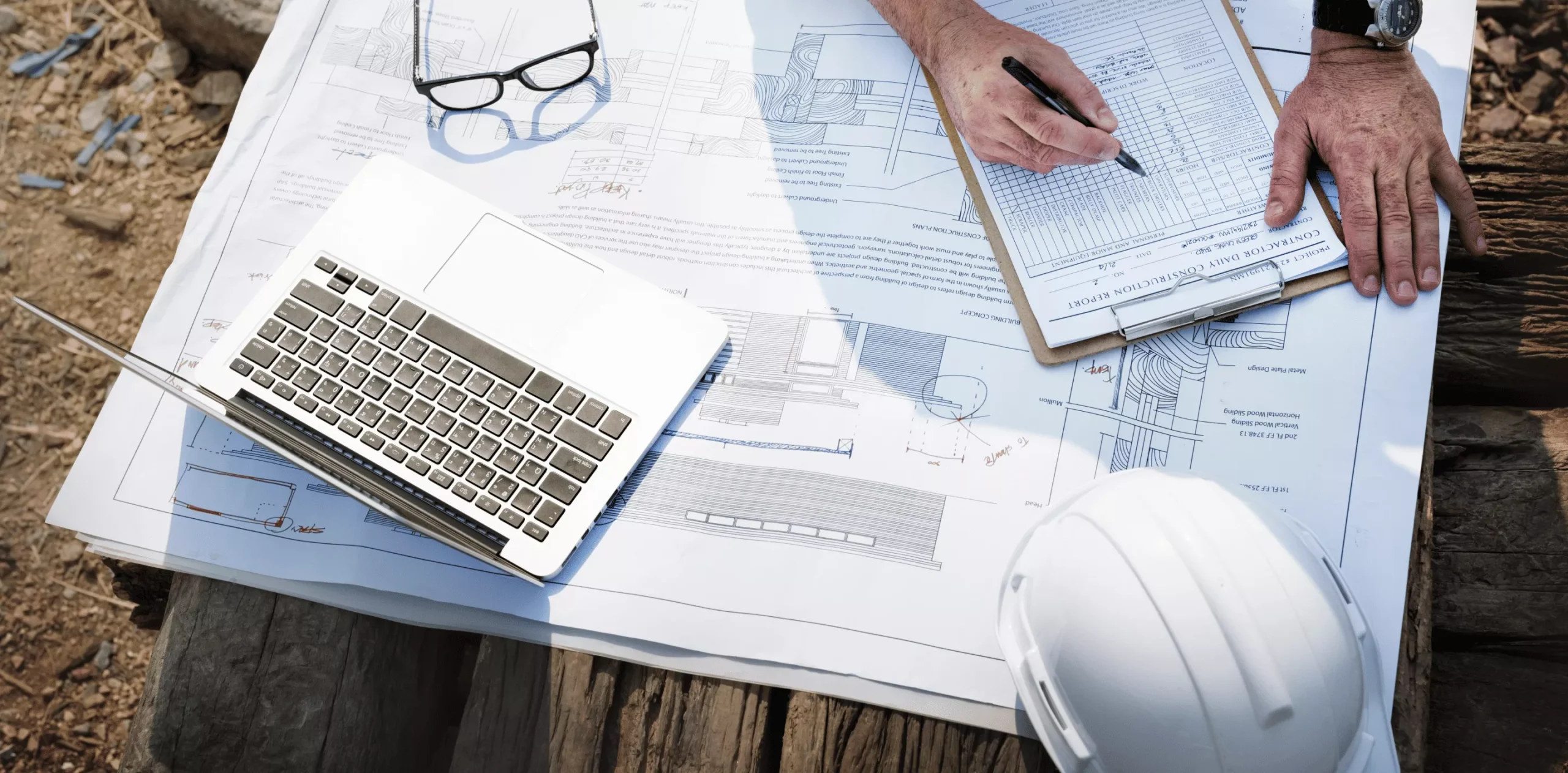 Laptop and plans on table