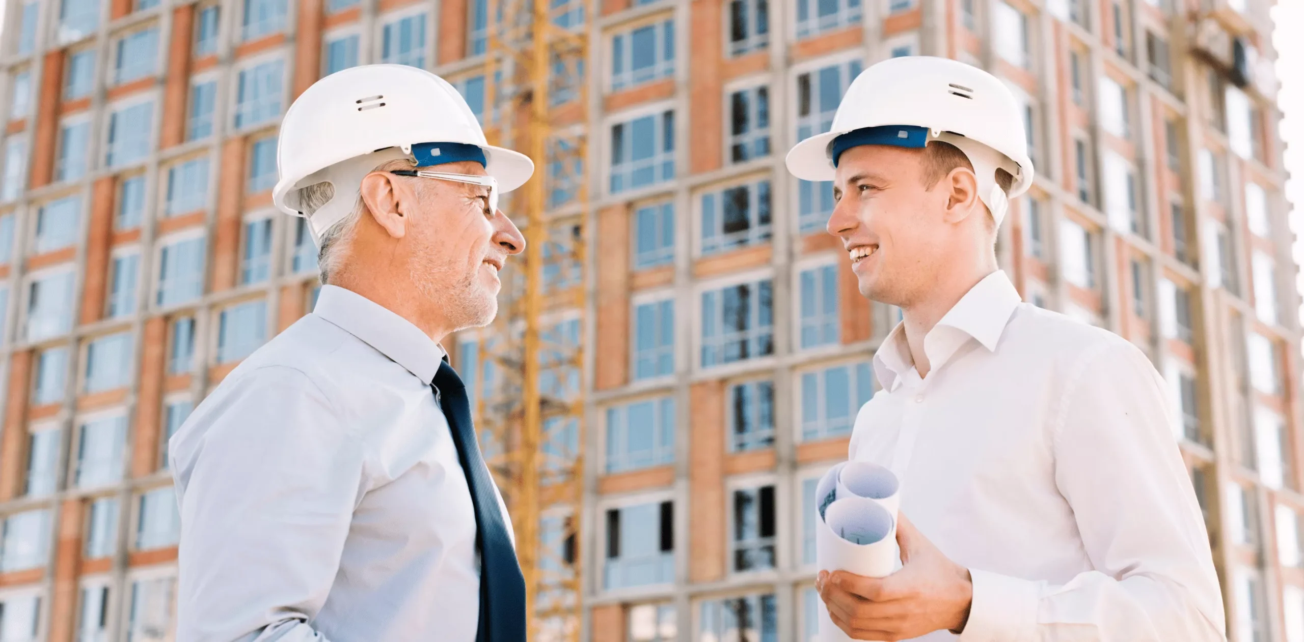 Two workers discussing construction plans