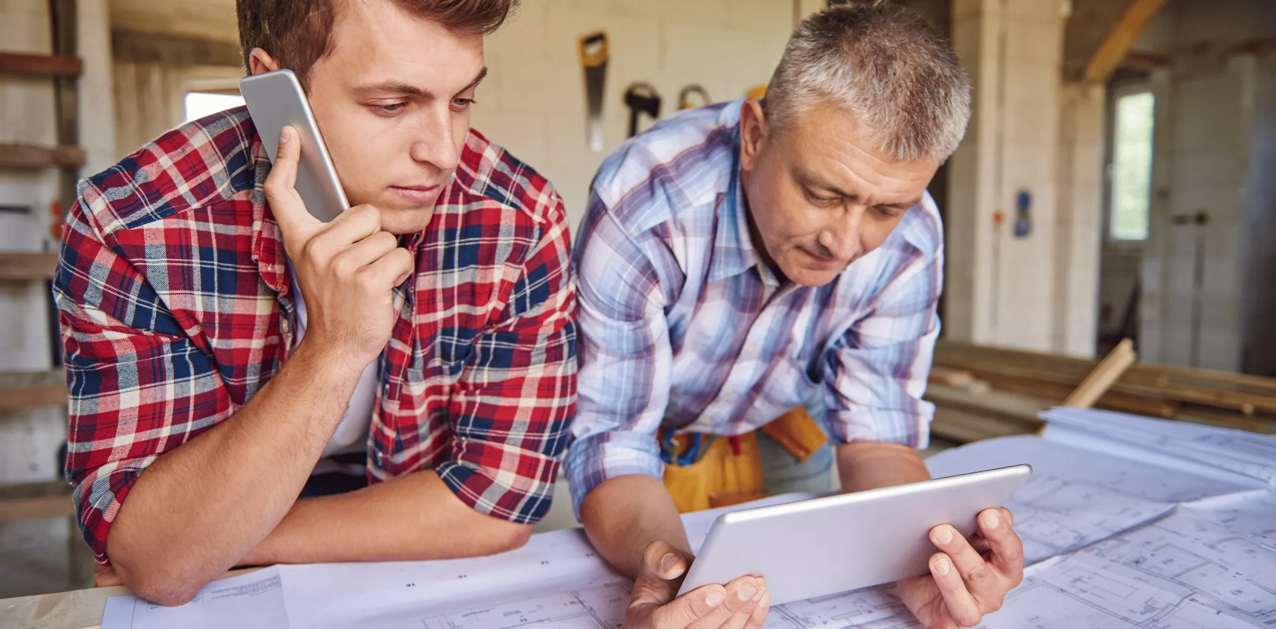 Two workers discussing plans