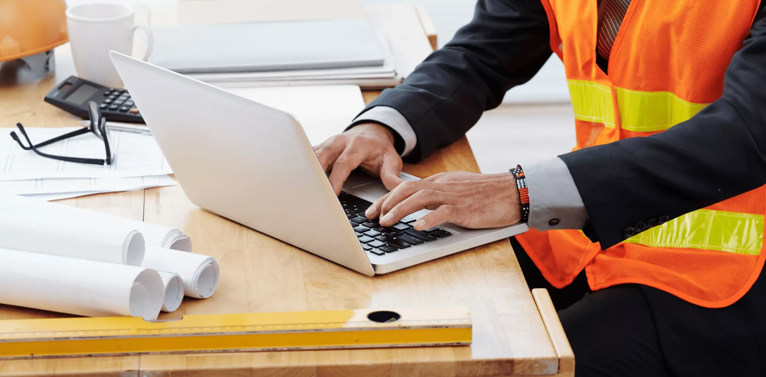 Worker typing on laptop